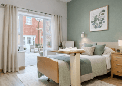 Bright bedroom with modern furnishings and direct access to a private outdoor patio area.